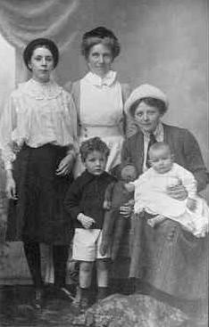 Ellen with Marjorie, Alaric and Clive on her lap, Nanny Finlay standing.