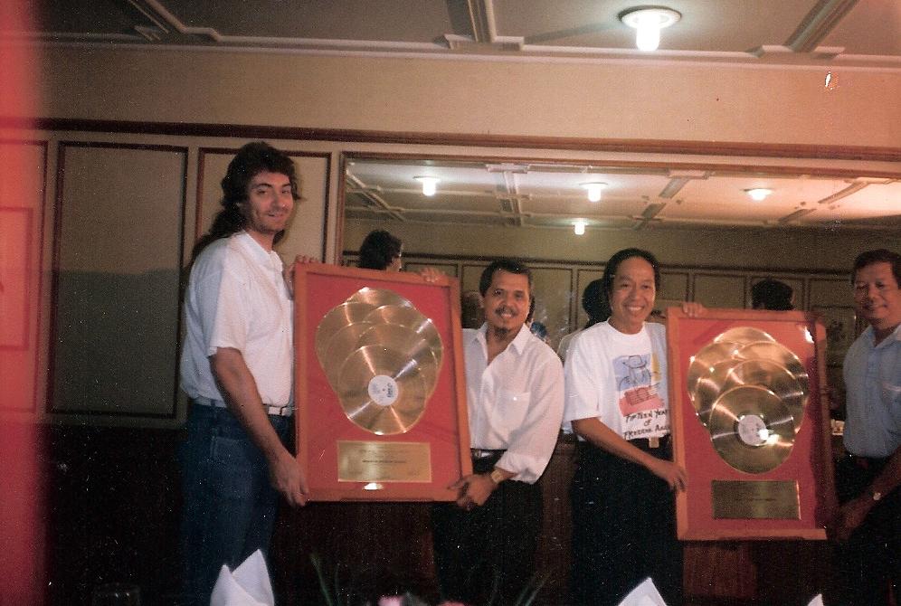 Gold records for producing Freddie Auilar.